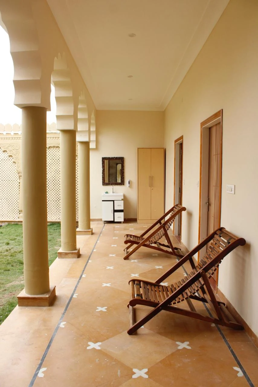 Heritage villa corridor with outdoor seating and traditional arches